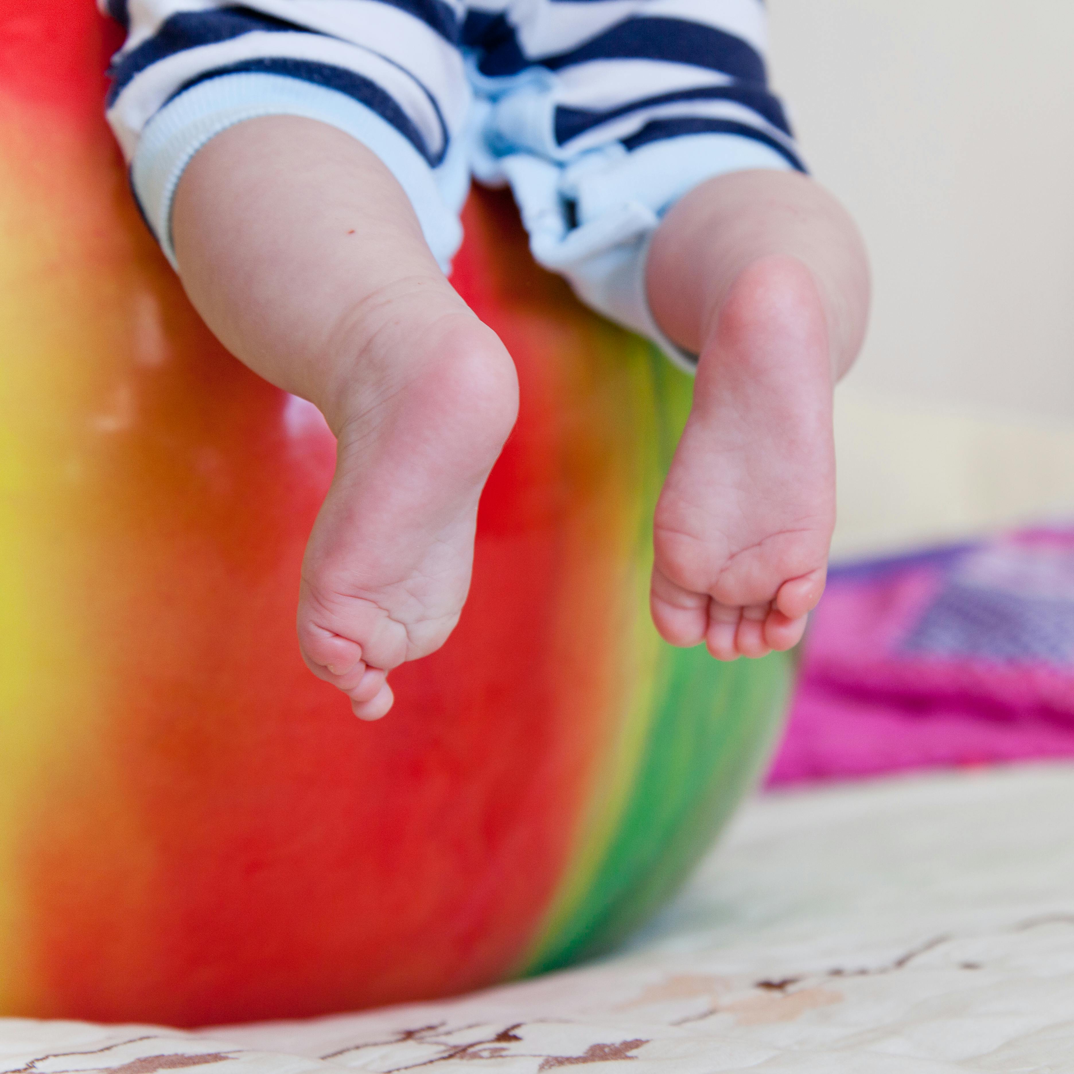Baby's Feet Covered With Black Wool Textile · Free Stock Photo