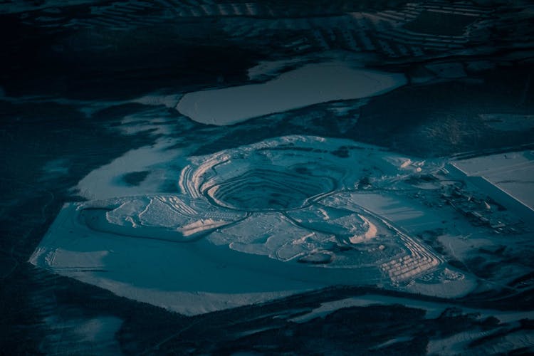 Snowy Terrain With Frozen Pond And Crater