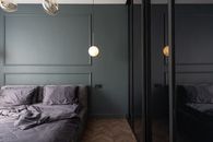 Stylish bedroom with unmade bed near cupboard