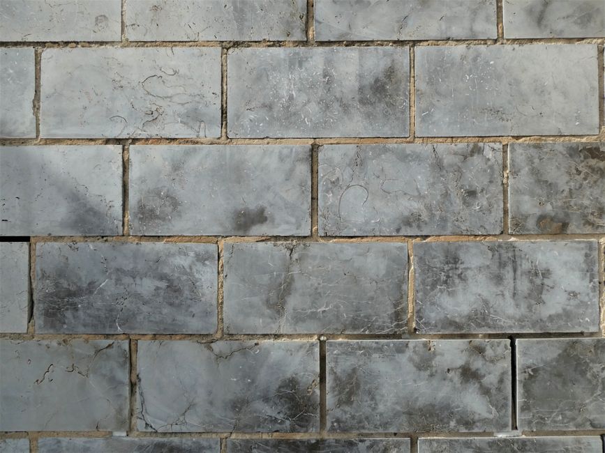 Close-up of textured ceramic wall tiles forming a uniform pattern.