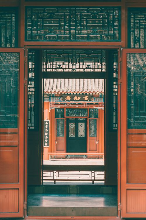 Free Captivating view of traditional Asian architecture with a detailed symmetrical doorway. Stock Photo