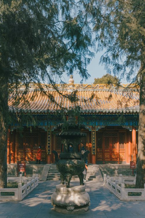 Free Serene scene of a traditional Chinese pavilion surrounded by summer trees. Stock Photo