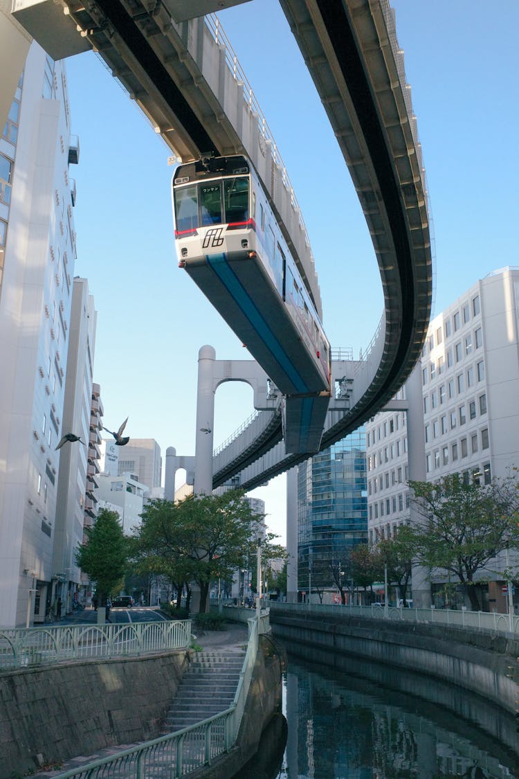 A Monorail Train Between High Rise Buildings