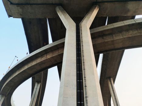 Low-angle shot of a modern concrete bridge in Bangkok, showcasing infrastructure design.