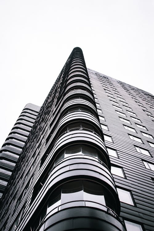 A Grayscale Photo of a Building Under the White Sky