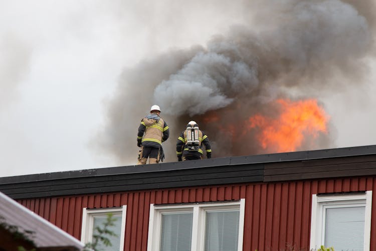 Firefighters On A Roof 