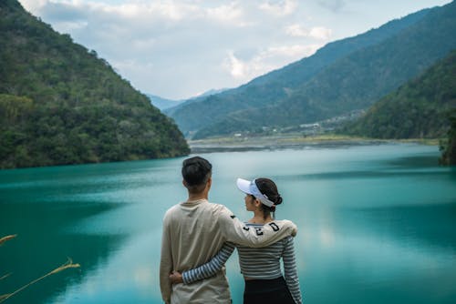 A Couple Standing Near Body of Water
