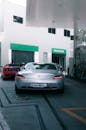 White Porsche 911 Parked in Front of Store
