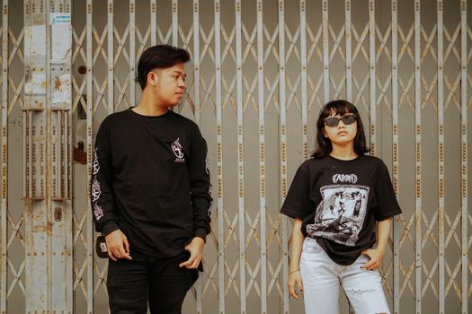 A Man in Black Sweater Looking at the Woman in Black Shirt Wearing Sunglasses