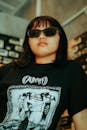 Woman in Black and White Crew Neck Shirt Wearing Black Sunglasses