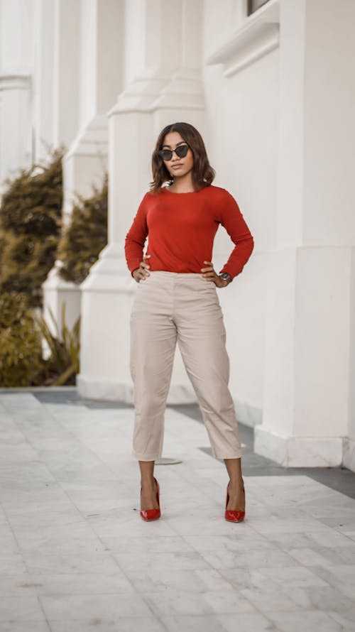 Woman in Red Long Sleeve Shirt Wearing Sunglasses