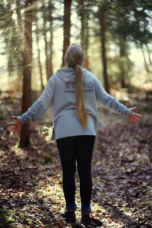 A Woman Standing in a Forest