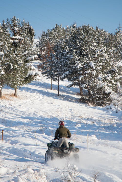 Free A Man Riding an ATV During Winter Stock Photo