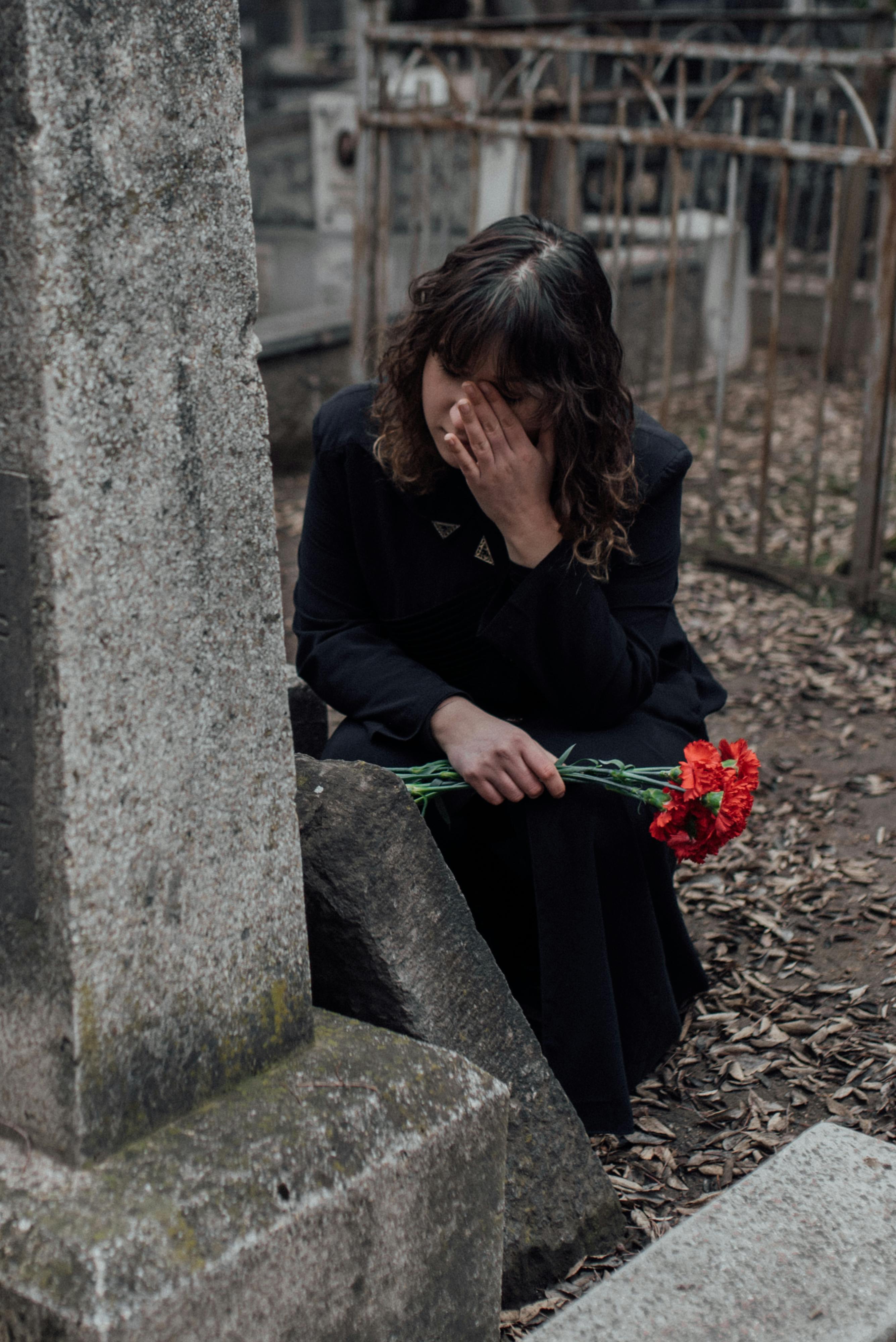 a woman crying at the cemetery