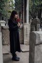 Woman in Black Long Sleeve Dress Holding Red Rose