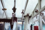 Brown Wooden Clothes Pin on White Metal Rack