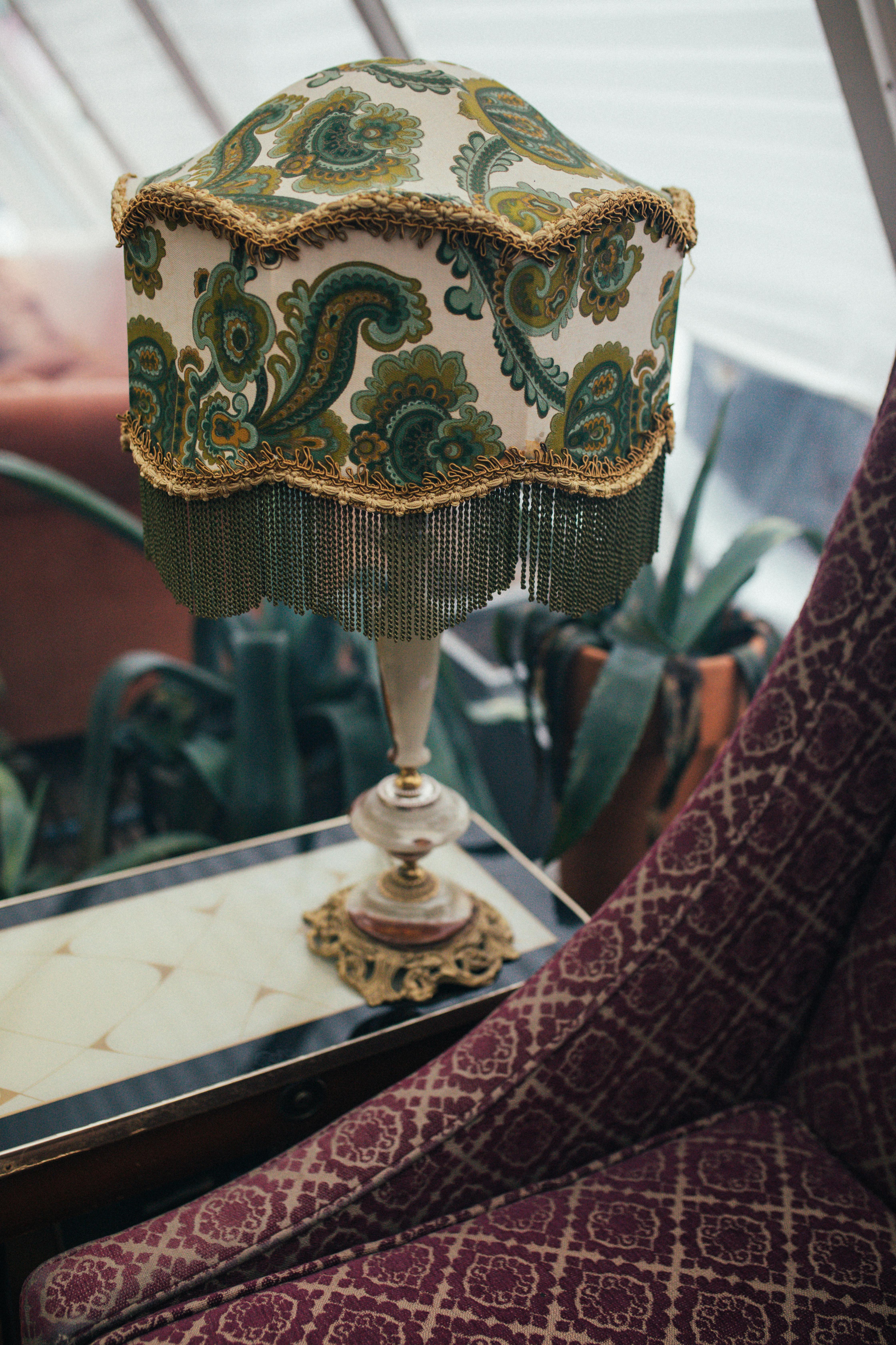 gold and green lamp on the table