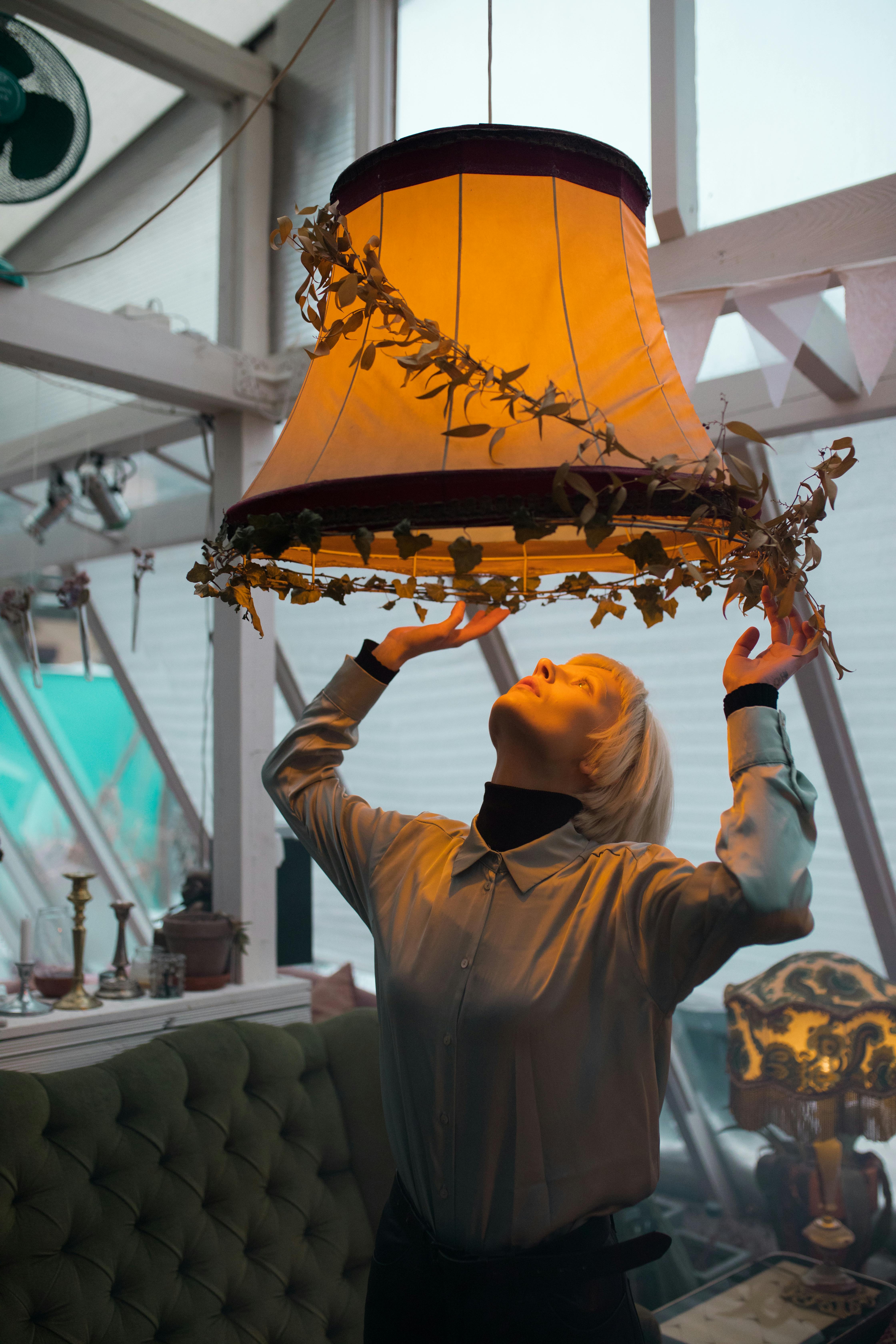 Man in Black Jacket Holding Brown Lantern