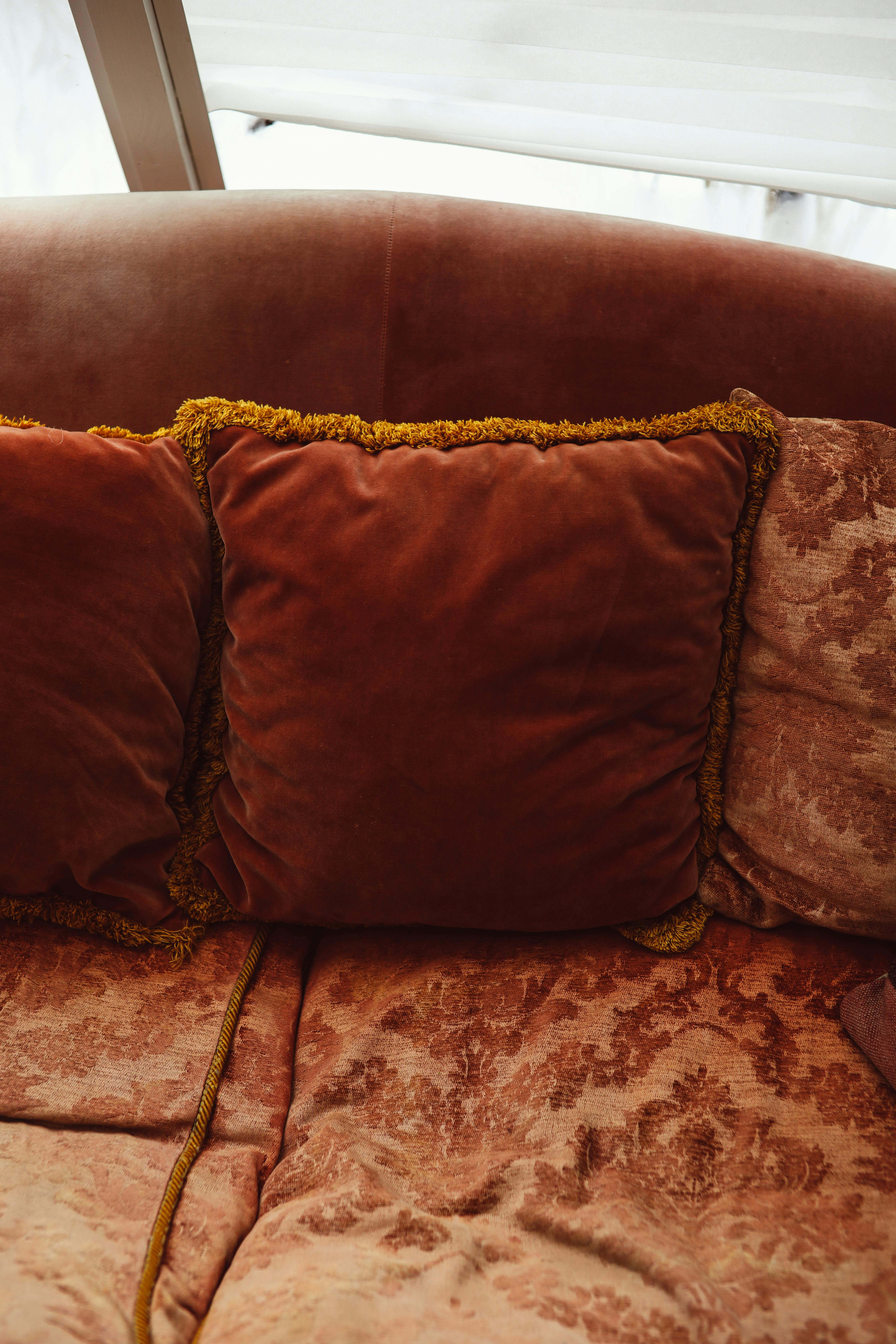 A Brown Leather Couch with Throw Pillows · Free Stock Photo
