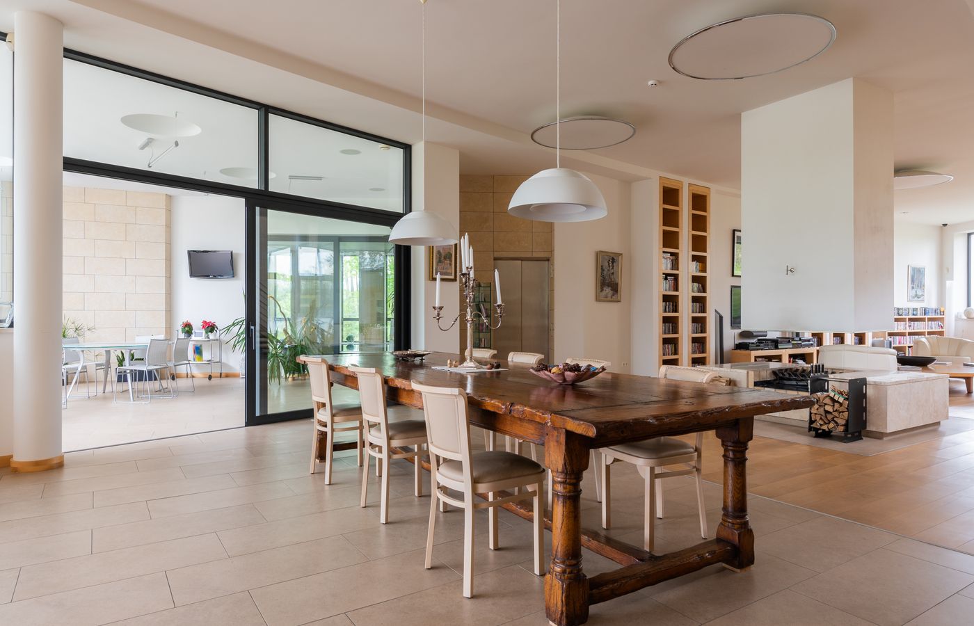 A chic dining room featuring a wooden table, elegant decor, and modern design elements.