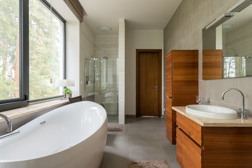 Bathroom with large window and white clean bathtub