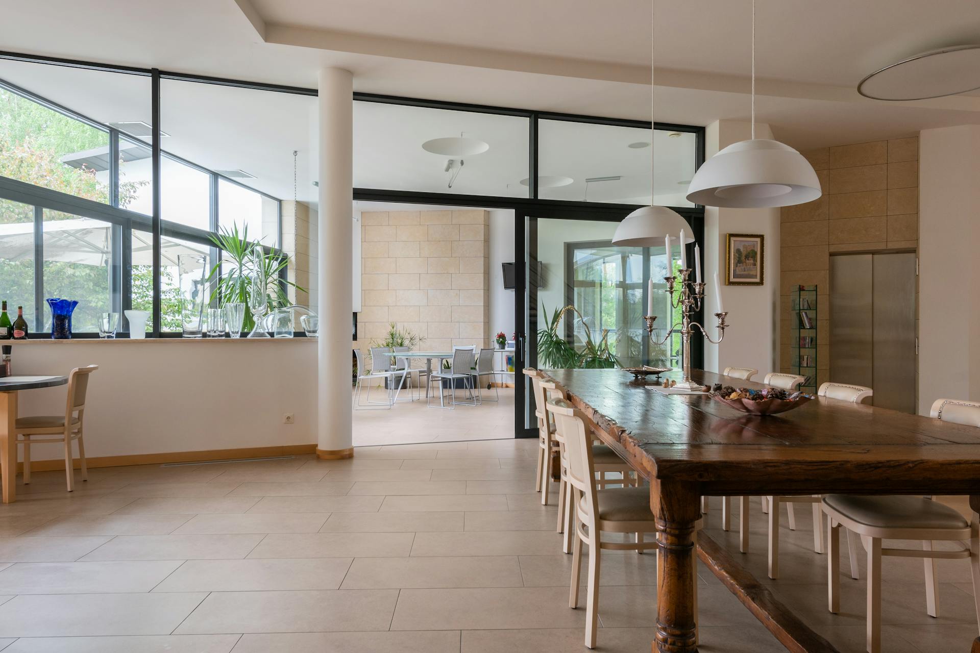 Dining room with wooden chairs and table under lamps