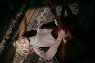 Girl in Gray Long Sleeve Shirt Playing Brown Acoustic Guitar