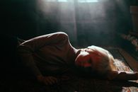 Woman in Brown Long Sleeve Shirt Lying on Floor