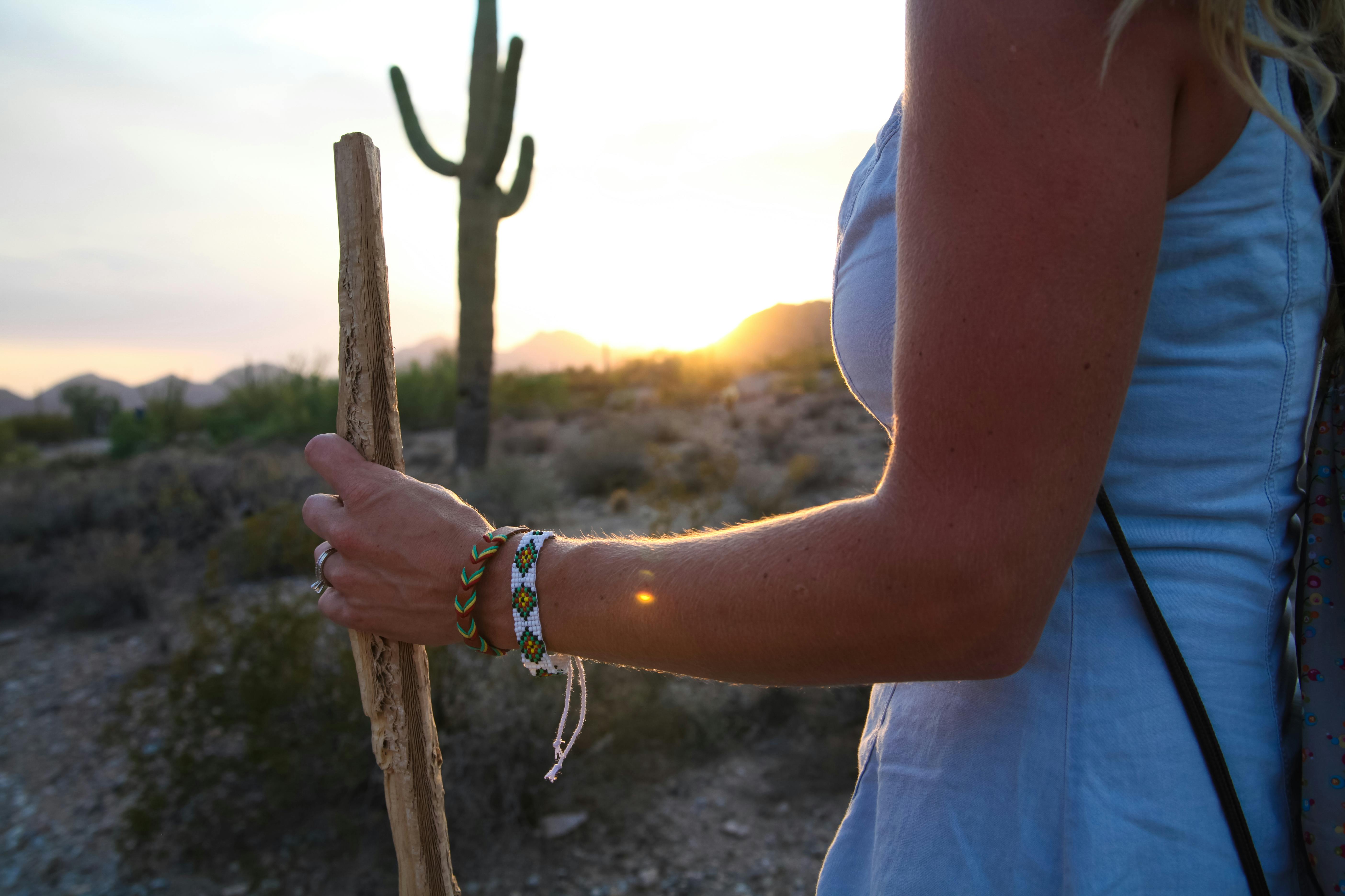 woman holding brown wood stick during daytime