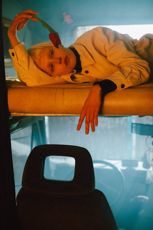 A Woman Lying on the Roof of the Car