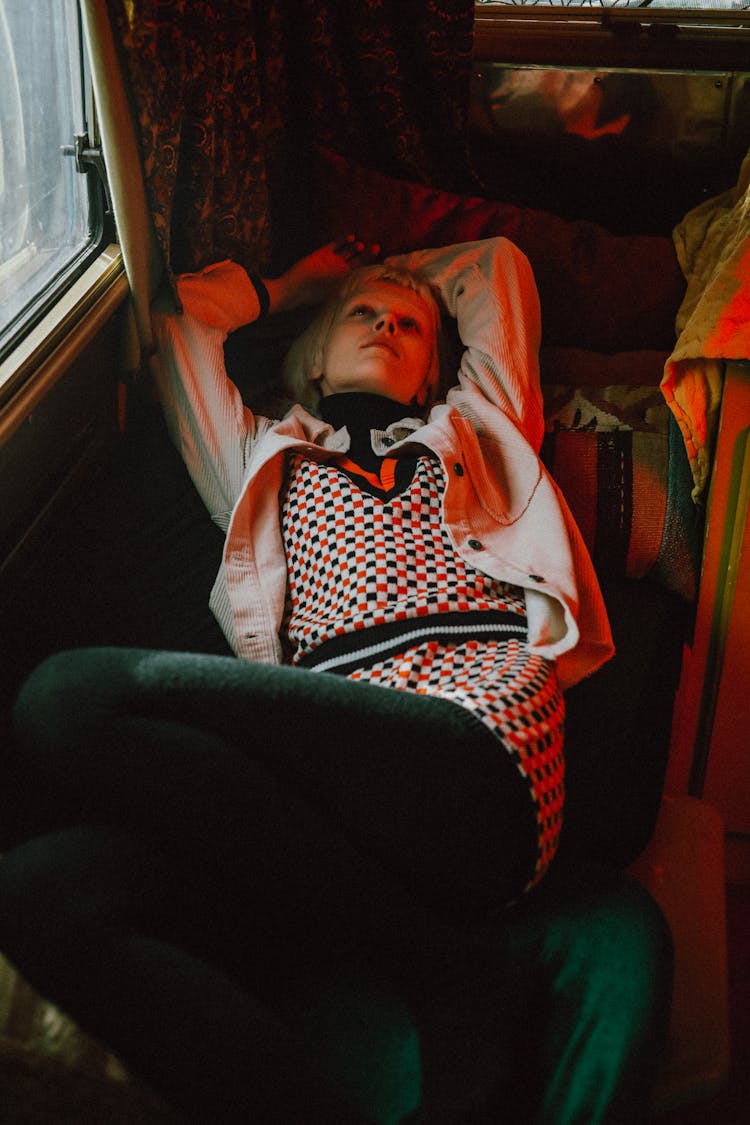 Blonde Woman Lying Down While Staring At The Ceiling