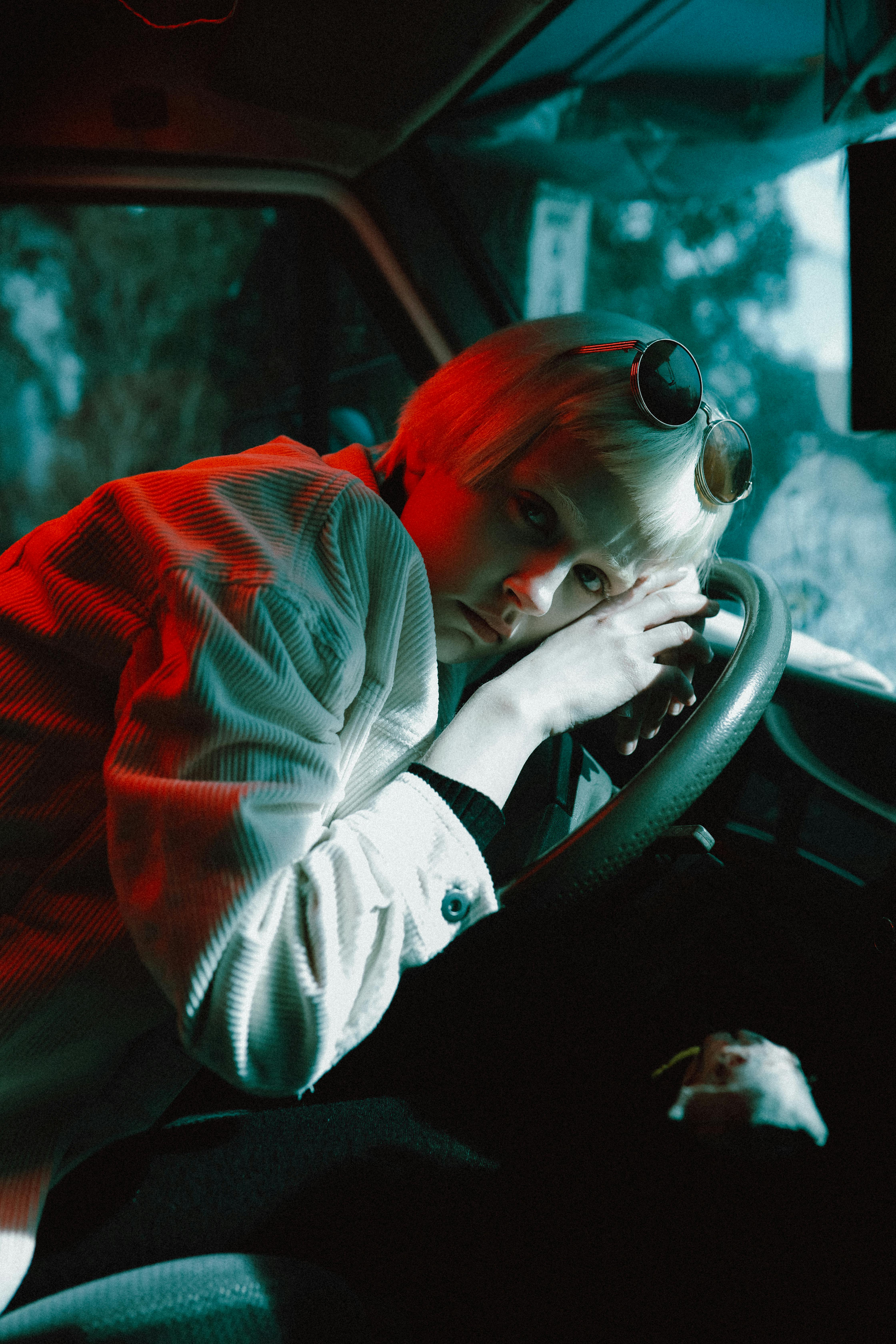 Woman in Red and White Hijab Sitting on Car Seat