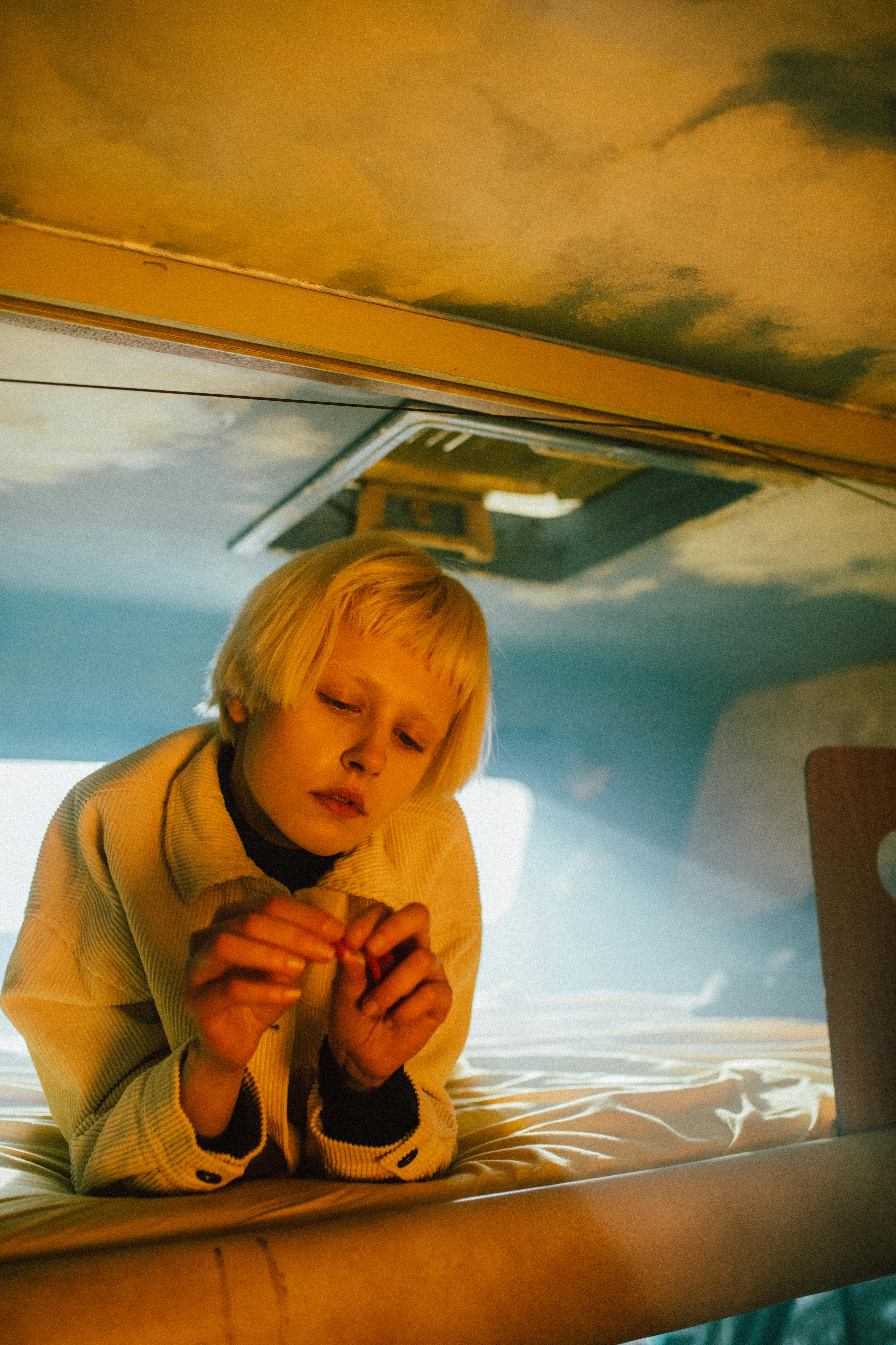 Woman in Beige Coat Sitting on Car Seat