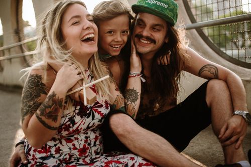Free A joyful family moment captured outdoors, showcasing love and togetherness at sunset. Stock Photo