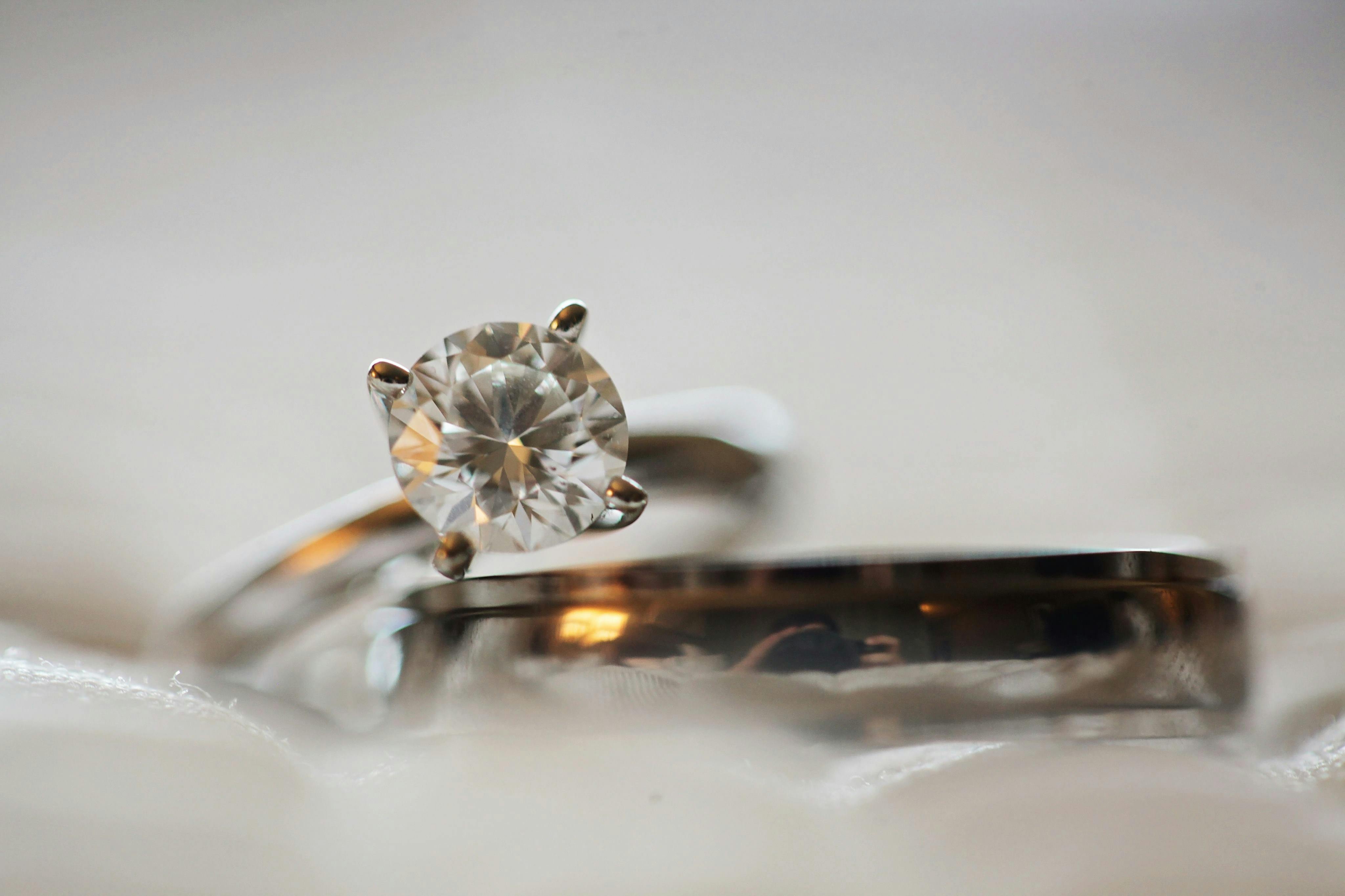 close up photo of diamond stud silver colored eternity ring