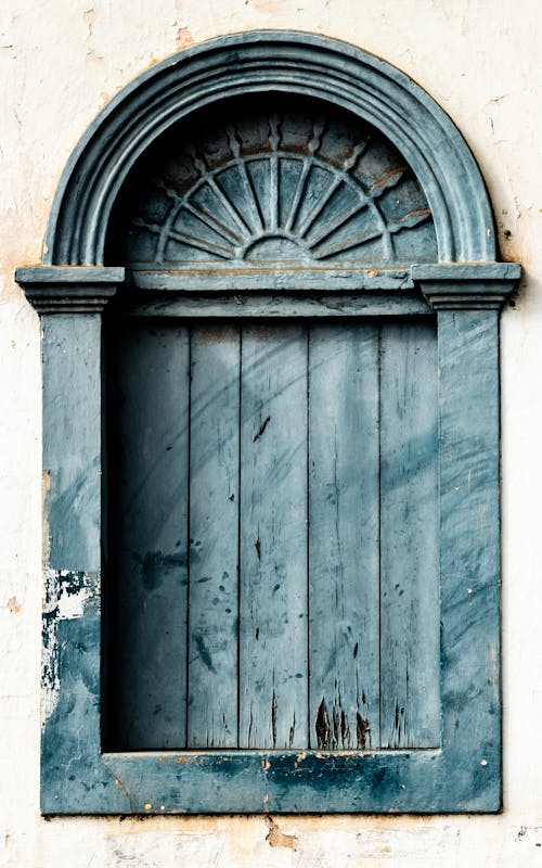 Blue Wooden Window on White Concrete Wall