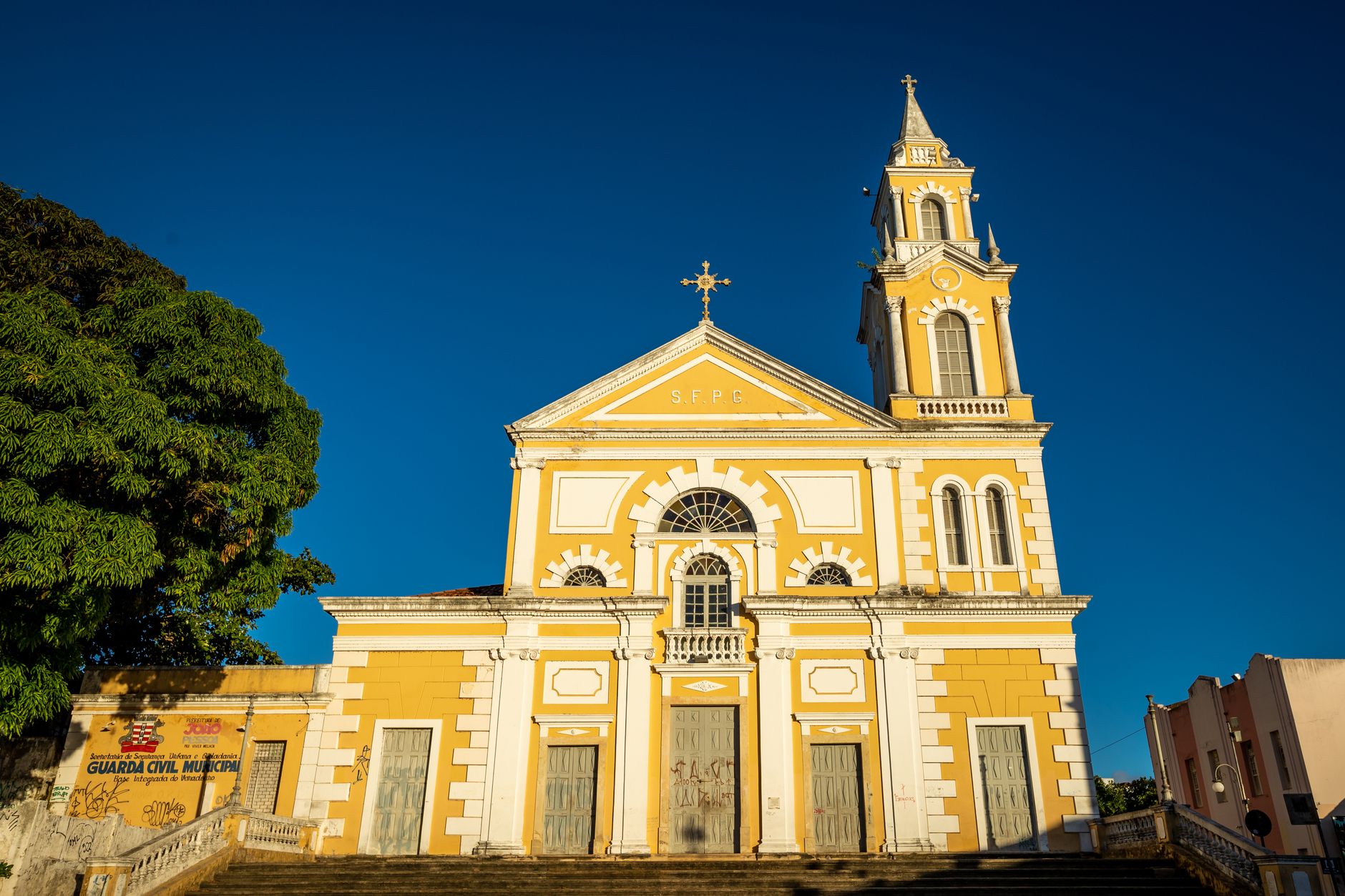 Beautiful exterior of historical basilica in João Pessoa, Brazil under clear blue sky.