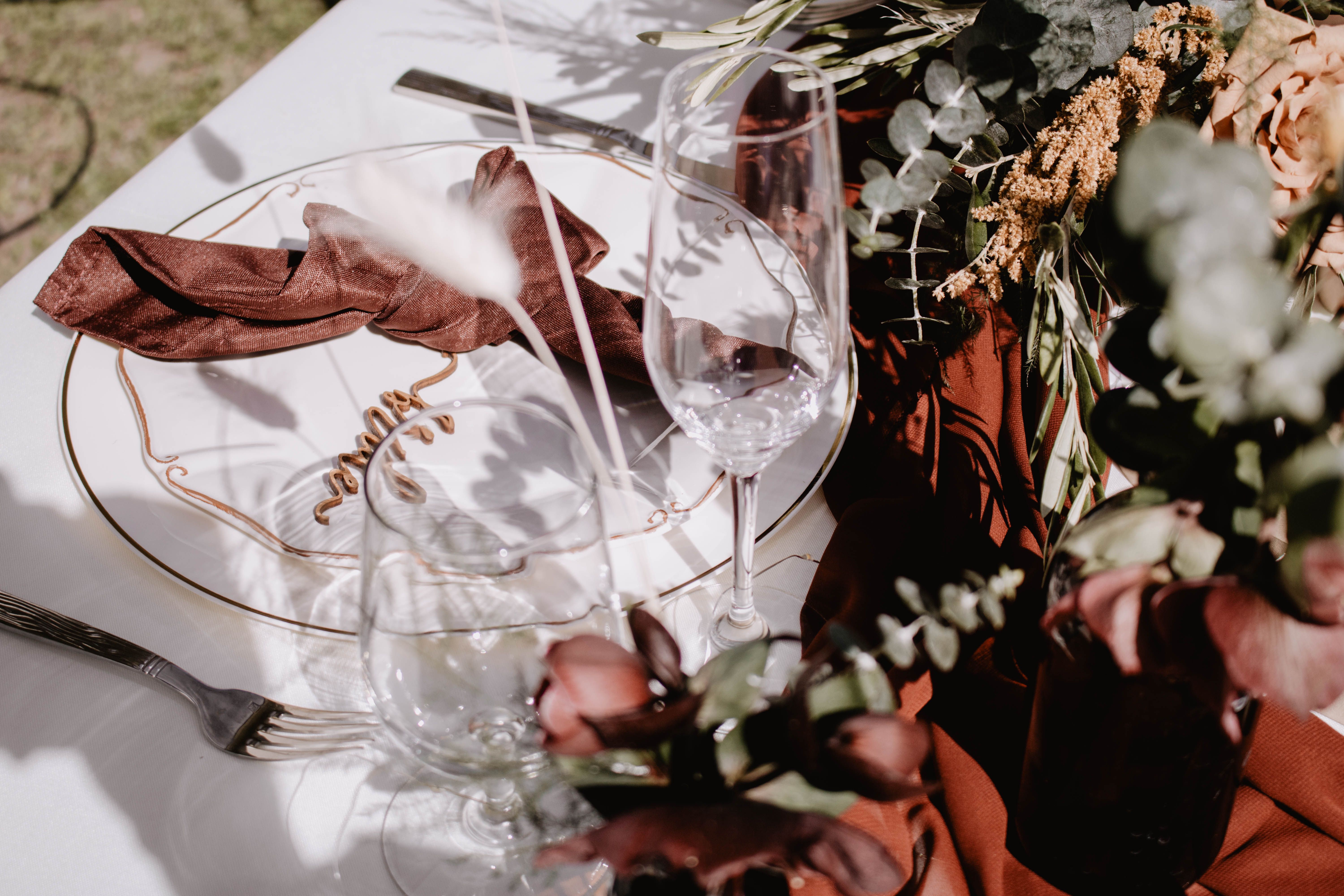 Beautifully arranged dining table with elegant tableware and floral decorations, perfect for an autumn event.