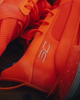 Close-up of vibrant orange sports sneakers in an artistic composition.