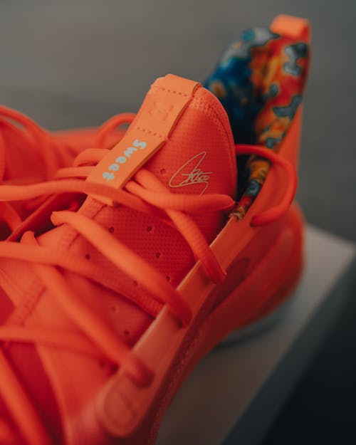 Free Stylish orange sneakers placed on box Stock Photo