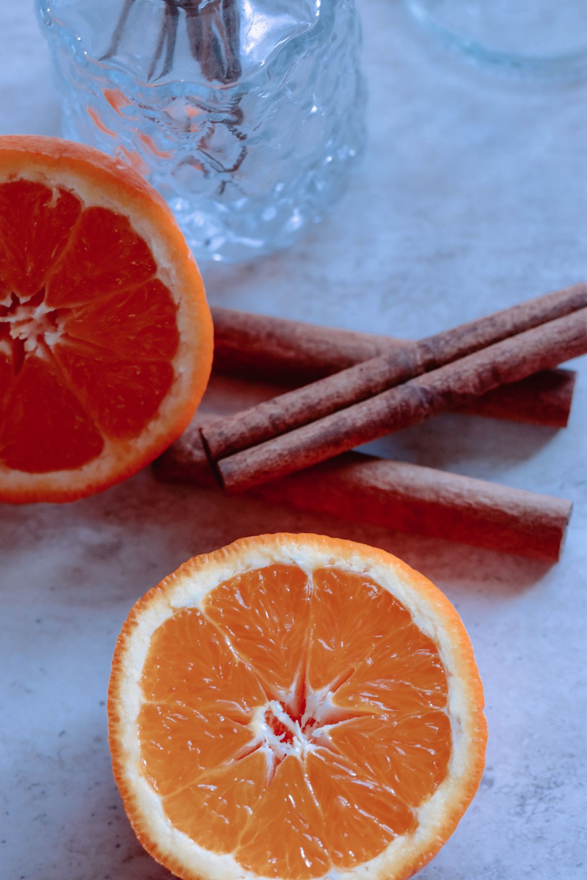 Fresh orange halves and cinnamon sticks — visual inspiration for Orange and Cinnamon