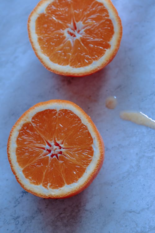 Free Fresh cut orange placed on marble table Stock Photo