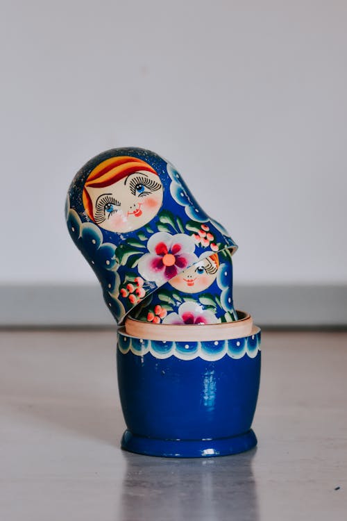 Set of traditional Russian wooden matryoshka doll with colorful ornamental painting placed on table