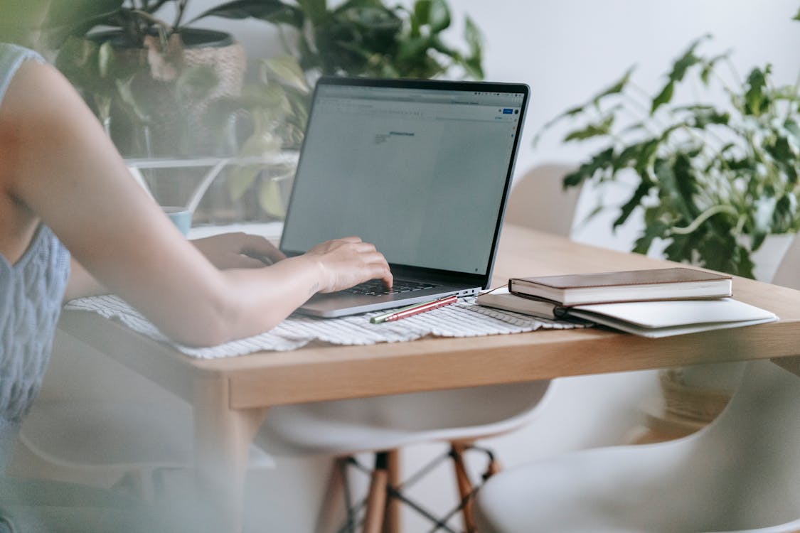 Free Woman working on laptop at home Stock Photo