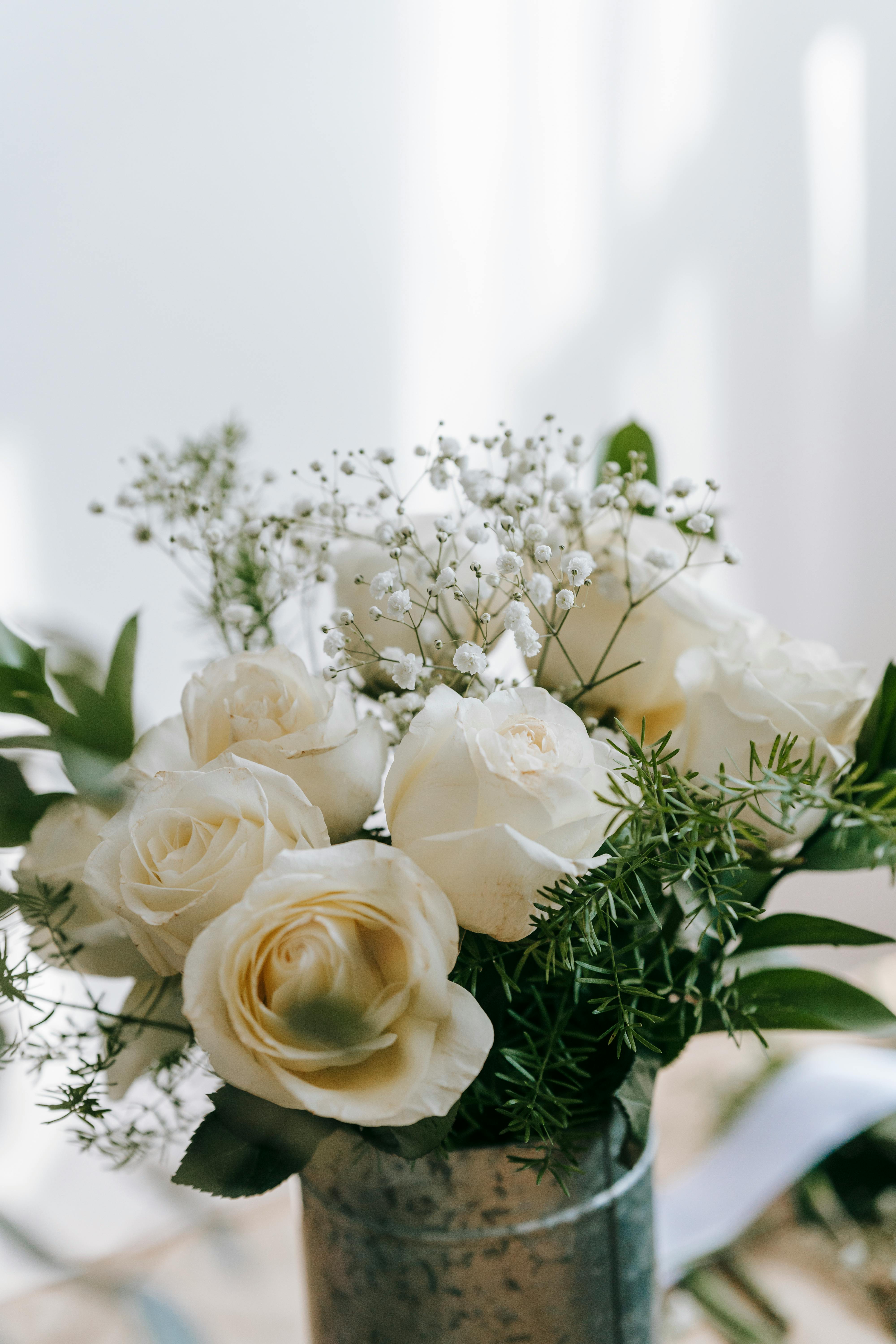 bouquet of fresh white roses in metal bucket