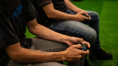 Free A Person in Black T-shirt Holding a Game Controller Stock Photo