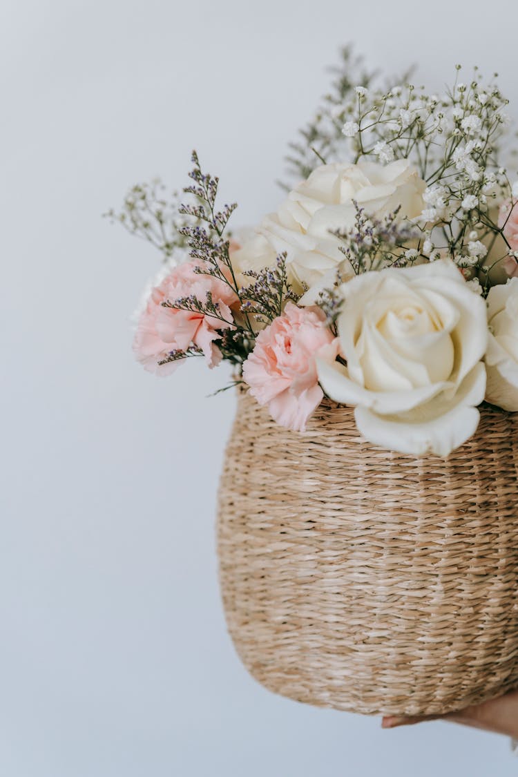 Wicker Basket With Flower Bouquet On White Background