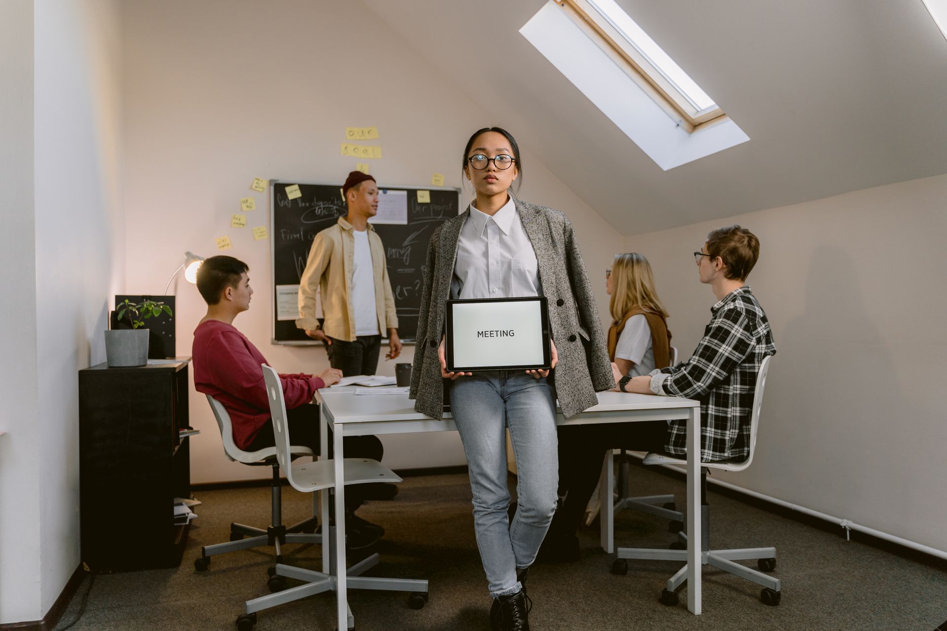 Diverse group of professionals brainstorming in a modern office setting.