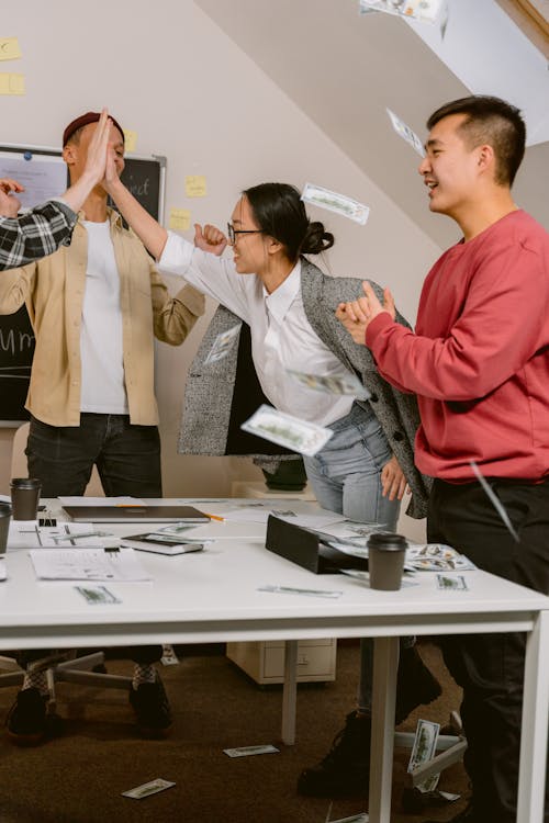 Free Officemates Celebrating For Their Success Stock Photo