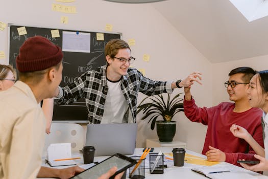 Dynamic group of young professionals engaging in teamwork at a creative office space.